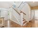 Bright foyer with hardwood floors, staircase, and stylish decor at 67 Lost Village Trl # 4, Edisto Island, SC 29438