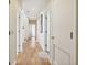 Bright hallway with hardwood floors, white doors, and access to different rooms at 67 Lost Village Trl # 4, Edisto Island, SC 29438