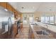 Well-equipped kitchen with stainless steel appliances, wooden cabinets, and a breakfast bar overlooking ocean view at 67 Lost Village Trl # 4, Edisto Island, SC 29438