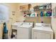 Functional laundry room with sink, shelving, and modern washer and dryer units at 67 Lost Village Trl # 4, Edisto Island, SC 29438