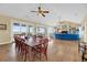 Open-concept living space featuring a dining area, hardwood floors, and a comfortable seating area with a fireplace at 67 Lost Village Trl # 4, Edisto Island, SC 29438
