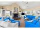 Spacious living room featuring bright blue sofas, a brick fireplace, and ample natural light at 67 Lost Village Trl # 4, Edisto Island, SC 29438