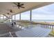 Spacious covered porch with ceiling fans, rocking chairs, and views of the ocean at 67 Lost Village Trl # 4, Edisto Island, SC 29438