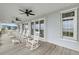 Open porch with rocking chairs provides an airy and scenic retreat with calming coastal views at 67 Lost Village Trl # 4, Edisto Island, SC 29438