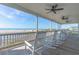 Inviting, covered porch with rocking chairs offers stunning views of the beach and ocean at 67 Lost Village Trl # 4, Edisto Island, SC 29438