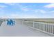 Relax on the rooftop deck with ocean views from comfortable blue Adirondack chairs at 67 Lost Village Trl # 4, Edisto Island, SC 29438
