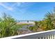 Stunning view of a beach with palm trees and blue skies visible from the house at 67 Lost Village Trl # 4, Edisto Island, SC 29438