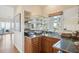 Wet bar featuring glass shelving, oak cabinets, tile countertop, and ocean view at 67 Lost Village Trl # 4, Edisto Island, SC 29438