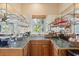 Wet bar featuring glass shelving, oak cabinets, tile countertop, and drinkware at 67 Lost Village Trl # 4, Edisto Island, SC 29438