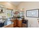 Wet bar featuring glass shelving, oak cabinets, tile countertop, and ocean view at 67 Lost Village Trl # 4, Edisto Island, SC 29438
