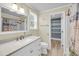 Bathroom features a large mirror over vanity with walk-in shower and tiled walls at 710 W Harrison Rd, Charleston, SC 29407