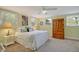 Bright bedroom features large windows, a comfortable bed, and a wooden wardrobe at 710 W Harrison Rd, Charleston, SC 29407