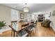 Spacious dining area with hardwood floors, chandelier lighting, and seating for six at 710 W Harrison Rd, Charleston, SC 29407