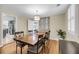 Charming dining area featuring a large wooden table, stylish chairs, and views into the kitchen at 710 W Harrison Rd, Charleston, SC 29407