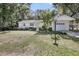 Lovely home with well-maintained lawn, mature trees, and detached garage at 710 W Harrison Rd, Charleston, SC 29407