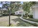Quaint home with a walkway and garden beds leading to a bright and welcoming entrance at 710 W Harrison Rd, Charleston, SC 29407