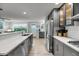 Open kitchen featuring modern appliances, an island with sink, and wood-look floors at 710 W Harrison Rd, Charleston, SC 29407