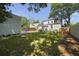 Well-maintained backyard with lush green grass, mature trees, and a wooden fence at 81 Avondale Ave, Charleston, SC 29407