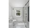 Modern bathroom featuring shiplap walls, a glass shower, and a bright window at 81 Avondale Ave, Charleston, SC 29407