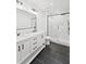 Bathroom featuring a dual sink vanity, black tile floors, and a glass shower at 81 Avondale Ave, Charleston, SC 29407