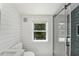 Modern bathroom featuring shiplap walls, a glass shower, and a bright window at 81 Avondale Ave, Charleston, SC 29407