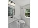 Bathroom featuring white shiplap walls, modern fixtures, and a tiled shower at 81 Avondale Ave, Charleston, SC 29407