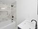 Elegant bathroom with a modern vanity, marble tiled walls around the soaking tub, and a rain shower head at 81 Avondale Ave, Charleston, SC 29407