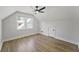 Charming bedroom featuring hardwood floors, a ceiling fan, and two large windows at 81 Avondale Ave, Charleston, SC 29407
