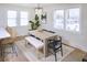 Bright dining area featuring a modern table set, stylish lighting, and large windows for abundant natural light at 81 Avondale Ave, Charleston, SC 29407