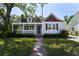 Charming home featuring a covered porch, manicured lawn, and delightful curb appeal at 81 Avondale Ave, Charleston, SC 29407