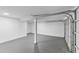 Spacious garage featuring a freshly painted floor, modern lighting, and a partially opened garage door at 81 Avondale Ave, Charleston, SC 29407
