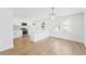 Modern kitchen with white cabinets, stainless steel appliances, and a stylish light fixture at 81 Avondale Ave, Charleston, SC 29407