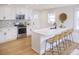 Kitchen featuring marble countertops, counter seating, stainless steel appliances, and ample natural light at 81 Avondale Ave, Charleston, SC 29407