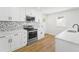 Updated kitchen features marble countertops, stainless steel appliances, and stylish backsplash at 81 Avondale Ave, Charleston, SC 29407