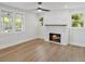 Bright living room featuring hardwood floors, a fireplace, and lots of natural light at 81 Avondale Ave, Charleston, SC 29407