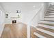 Bright living room featuring hardwood floors, a fireplace, and a modern staircase at 81 Avondale Ave, Charleston, SC 29407