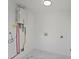 Clean and modern utility room with marble tile floors, and a tankless water heater at 81 Avondale Ave, Charleston, SC 29407