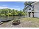 Backyard with river access, fire pit, and a white building at 8487 Parkers Ferry Rd, Adams Run, SC 29426