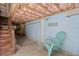Basement area with block walls, wood stairs, and a blue chair at 8487 Parkers Ferry Rd, Adams Run, SC 29426