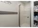Bathroom shower stall with organized shelves and decorative mosaic tile accent at 8487 Parkers Ferry Rd, Adams Run, SC 29426