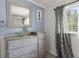 Bathroom with elegant vanity, decor, and a large window at 8487 Parkers Ferry Rd, Adams Run, SC 29426
