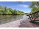 Peaceful waterfront scene featuring a wooden dock with partial railing and calm river views at 8487 Parkers Ferry Rd, Adams Run, SC 29426