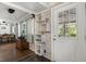 Entryway and hallway featuring a wooden chest, hanging decor, and a view of the outdoor area at 8487 Parkers Ferry Rd, Adams Run, SC 29426