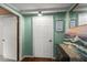 Hallway with wood floors, adjacent doors, and sea-foam green walls at 8487 Parkers Ferry Rd, Adams Run, SC 29426