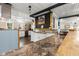 A kitchen bar area with a stainless steel sink, white cabinets, wooden accents, and an open floor plan at 8487 Parkers Ferry Rd, Adams Run, SC 29426