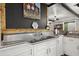 The kitchen sink area features a large stainless steel sink with white cabinets below and wooden accents at 8487 Parkers Ferry Rd, Adams Run, SC 29426