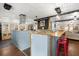 Kitchen area with blue counter, wooden bar top, and stainless steel range hood at 8487 Parkers Ferry Rd, Adams Run, SC 29426