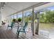 Charming waterfront porch with cozy seating, plants, and serene river views for relaxing or entertaining guests at 8487 Parkers Ferry Rd, Adams Run, SC 29426