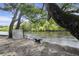 Picturesque riverfront view with mature trees and sandy shoreline at 8487 Parkers Ferry Rd, Adams Run, SC 29426