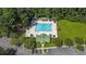 Stunning aerial view of community pool with lounge chairs, a playground, and lush landscaping at 86 Cross Timbers Dr, Summerville, SC 29485